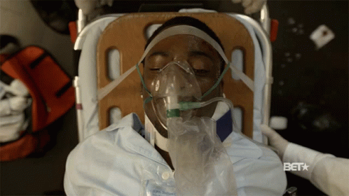 A Man Wearing An Oxygen Mask Is Laying On A Stretcher With The Bet Logo Visible GIF