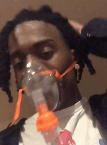 A Man Wearing An Oxygen Mask On His Face GIF