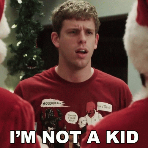 A Man Wearing An Ugly Christmas Sweater With The Words I 'M Not A Kid On The Bottom GIF