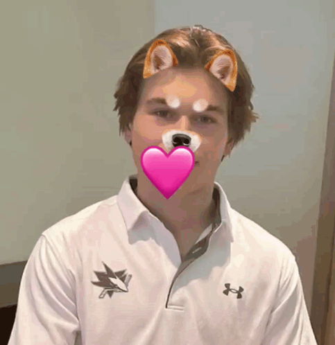 A Man Wearing An Under Armour Shirt Has A Heart In His Mouth GIF