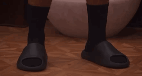 a man wearing black socks and black sandals