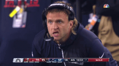 A Man Wearing Bose Headphones Is Watching A Game GIF