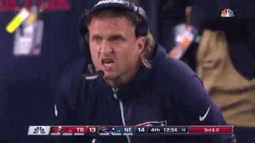 A Man Wearing Bose Headphones Is Watching A Game GIF