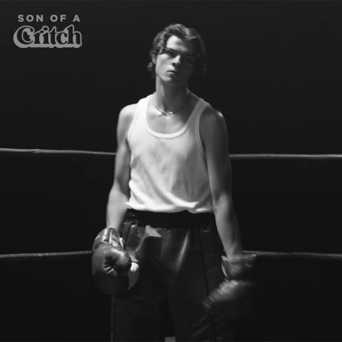 A Man Wearing Boxing Gloves Is In A Boxing Ring With The Words Son Of A Critch Above Him GIF