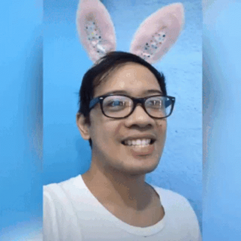 A Man Wearing Bunny Ears And Glasses Is Making A Funny Face GIF