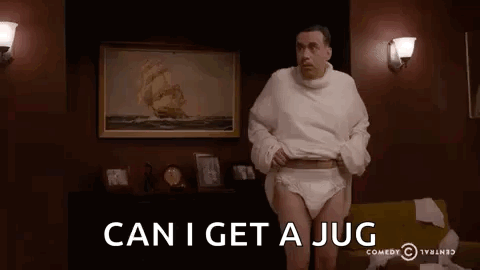 A Man Wearing Diapers And A Sweater Is Standing In A Living Room With The Words `` Can I Get A Jug '' . GIF