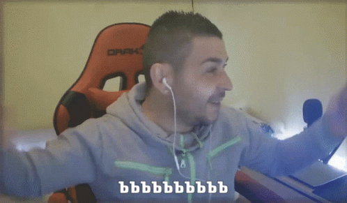 A Man Wearing Ear Buds And A Grey Hoodie Is Pointing At The Camera With The Words He He He And He Written Below Him GIF