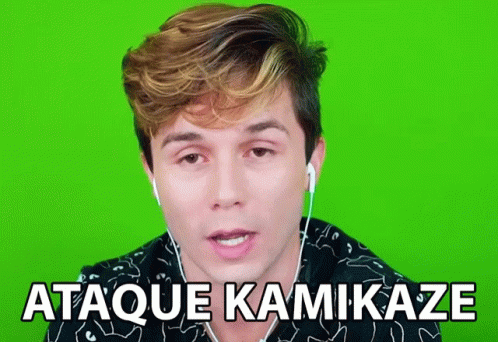 a man wearing ear buds says " ataque kamikaze " in front of a green screen