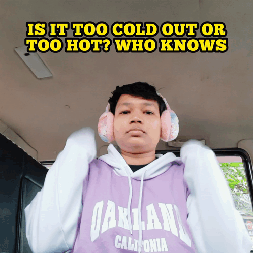 A Man Wearing Ear Muffs And A Hoodie That Says Oakland California On It GIF