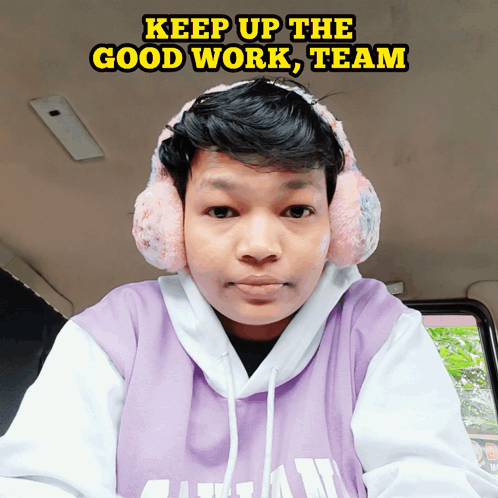 A Man Wearing Ear Muffs And A Purple Shirt With The Words Keep Up The Good Work Team Written Above Him GIF