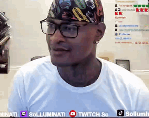A Man Wearing Glasses And A Bandana Is Sitting In Front Of A Twitch So Banner GIF