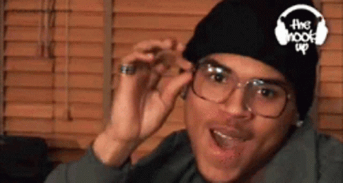 A Man Wearing Glasses And A Beanie Has The Hook Up Logo On His Hat GIF