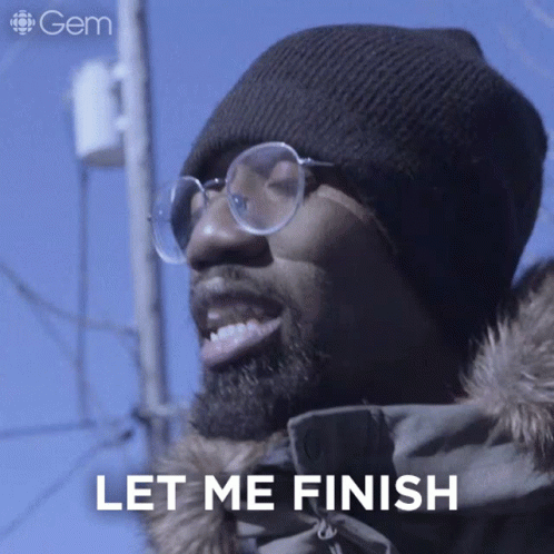 A Man Wearing Glasses And A Beanie Is Smiling And Says Let Me Finish GIF