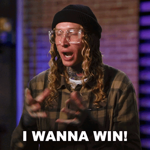 A Man Wearing Glasses And A Beanie Says " I Wanna Win " GIF
