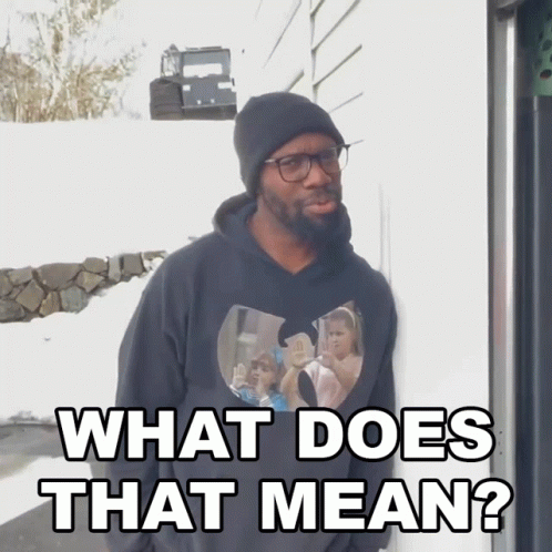 A Man Wearing Glasses And A Black Hoodie Says What Does That Mean GIF