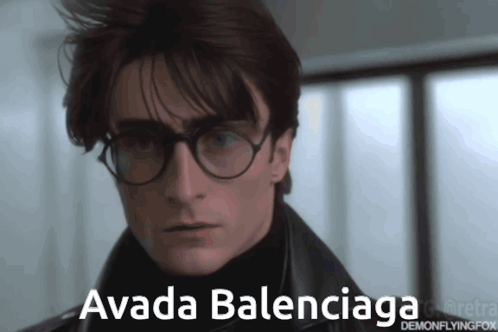 A Man Wearing Glasses And A Black Jacket Has The Name Avada Balenciaga On His Face GIF
