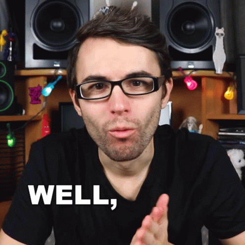 A Man Wearing Glasses And A Black Shirt Says Well In White Letters GIF