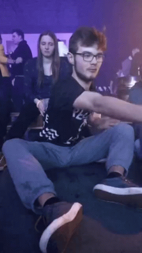 A Man Wearing Glasses And A Black Shirt That Says E On It GIF