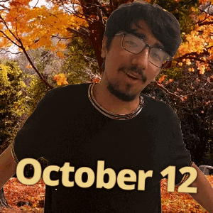 A Man Wearing Glasses And A Black Shirt That Says October 12 On It GIF