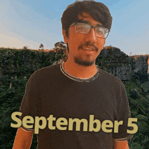 A Man Wearing Glasses And A Black Shirt That Says September 5 On It GIF