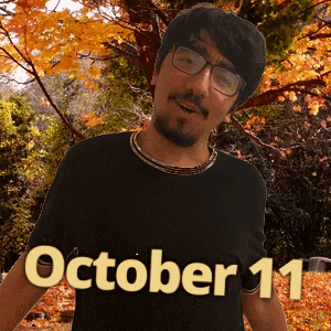 A Man Wearing Glasses And A Black Shirt With October 11 On It GIF