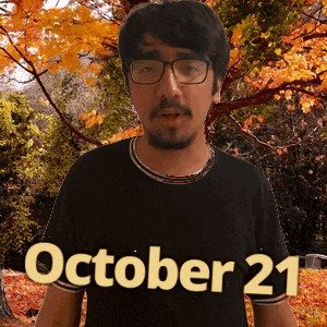 A Man Wearing Glasses And A Black Shirt With The Date Of October 21 GIF