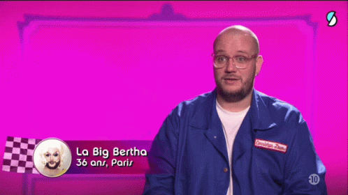 A Man Wearing Glasses And A Blue Jacket Says La Big Bertha GIF