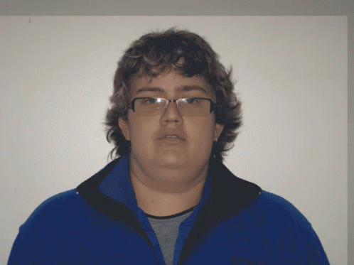 A Man Wearing Glasses And A Blue Jacket That Says Patagonia On It GIF