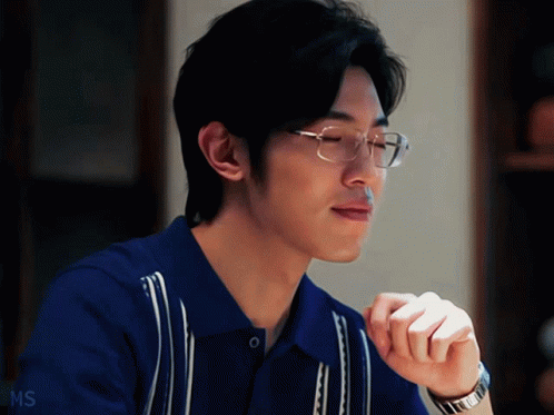 A Man Wearing Glasses And A Blue Shirt Has Ms Written On The Bottom Right GIF