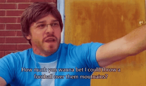 A Man Wearing Glasses And A Blue Shirt Says How Much You Wanna Bet I Could Throw A Football Over Them Mountains GIF