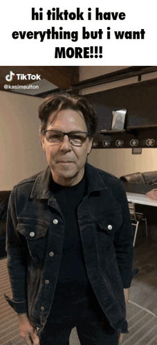a man wearing glasses and a denim jacket says hi tiktok i have everything but i want more ..