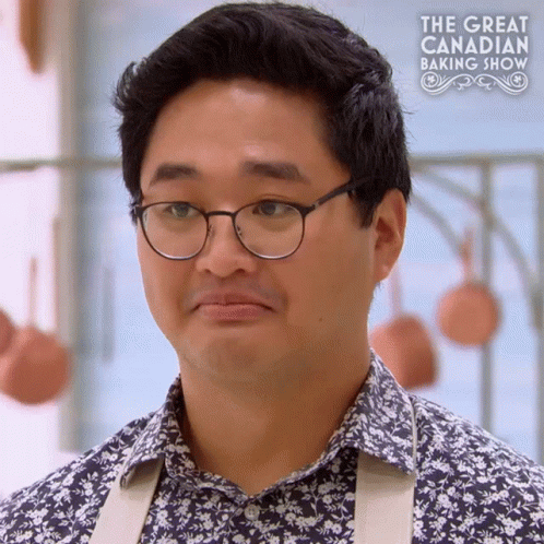 A Man Wearing Glasses And A Floral Shirt Is On A Tv Show Called The Great Canadian Baking Show GIF