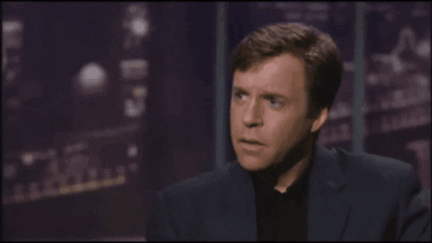 A Man Wearing Glasses And A Fur Coat Is Talking About What The Hell Are You Talking About GIF