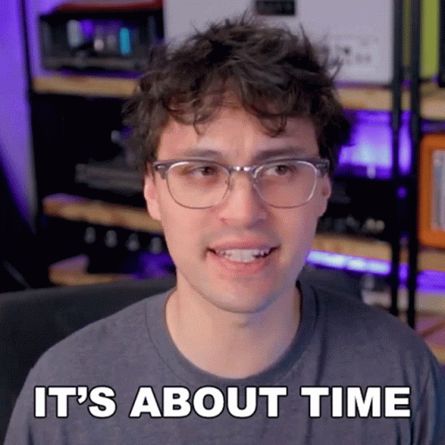 A Man Wearing Glasses And A Gray Shirt Says It 'S About Time GIF