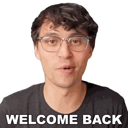 a man wearing glasses and a gray shirt says welcome back