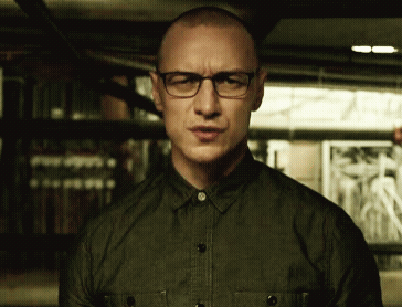 A Man Wearing Glasses And A Green Shirt Is Making A Face GIF