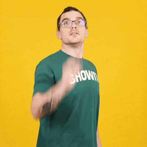 A Man Wearing Glasses And A Green Shirt That Says Shown On It GIF