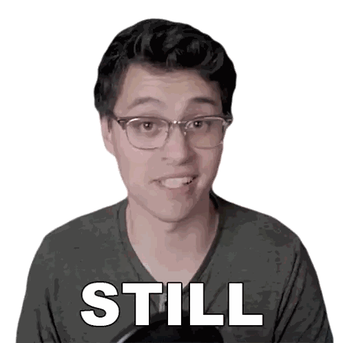 a man wearing glasses and a green shirt with the word still written on his face