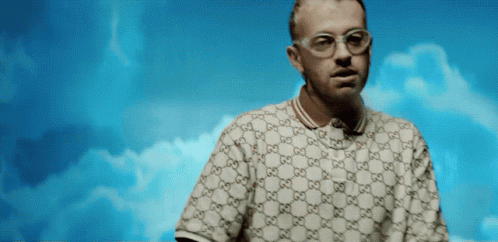 a man wearing glasses and a gucci polo shirt
