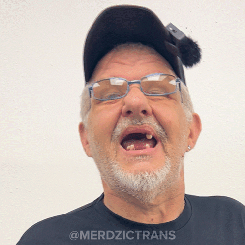 A Man Wearing Glasses And A Hat Has The Word Merdzictrans On The Bottom GIF