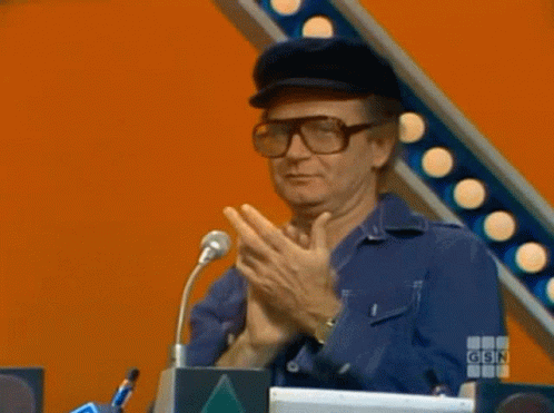 A Man Wearing Glasses And A Hat Is Giving A Thumbs Up Sign GIF