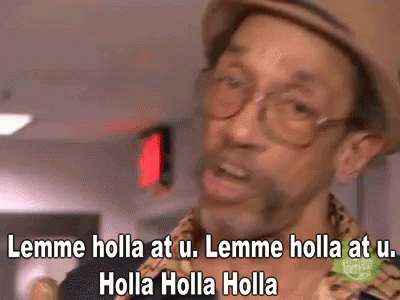 A Man Wearing Glasses And A Hat Is Saying Lemme Holla At U. GIF