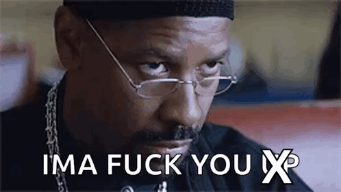 A Man Wearing Glasses And A Hat Is Sitting At A Table And Saying `` Ima Fuck You X '' . GIF