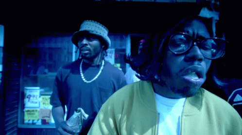 Man With Glasses And Hat In Front Of Store GIF