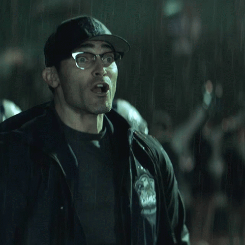A Man Wearing Glasses And A Hat With The Letter B On It Is Making A Funny Face GIF