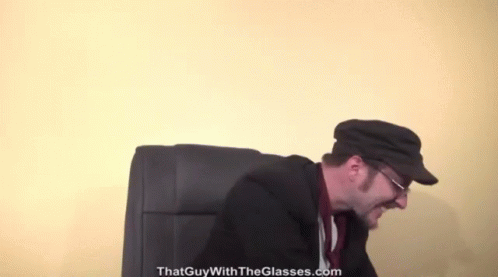 A Man Wearing Glasses And A Hat With The Website Thatguywiththeglasses.com In The Corner GIF