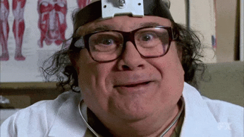 A Man Wearing Glasses And A Headband Is Holding A Stethoscope To His Ear . GIF