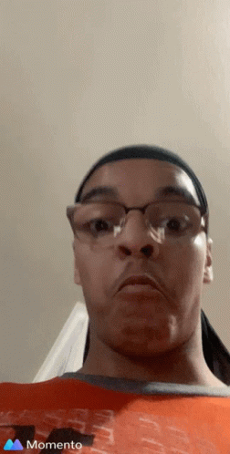 A Man Wearing Glasses And A Headband Is Making A Funny Face In A Momento Photo GIF