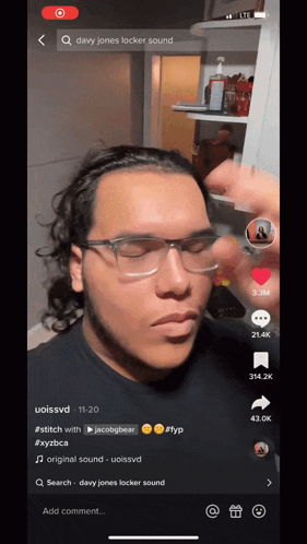 A Man Wearing Glasses And A Headband Is On A Tiktok Video GIF