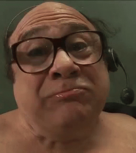 A Man Wearing Glasses And A Headset Is Eating Corn GIF